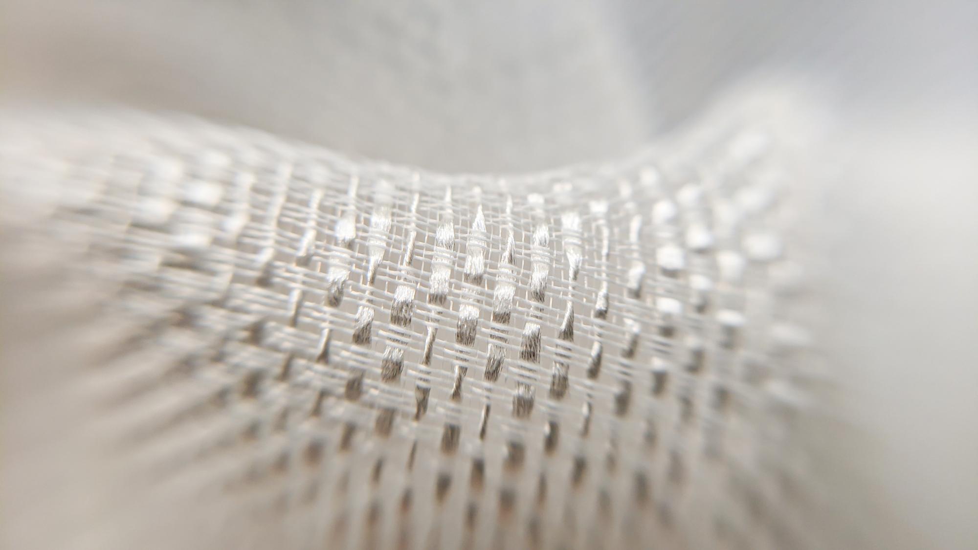 Close-up of metallic thread detail on white fabric
