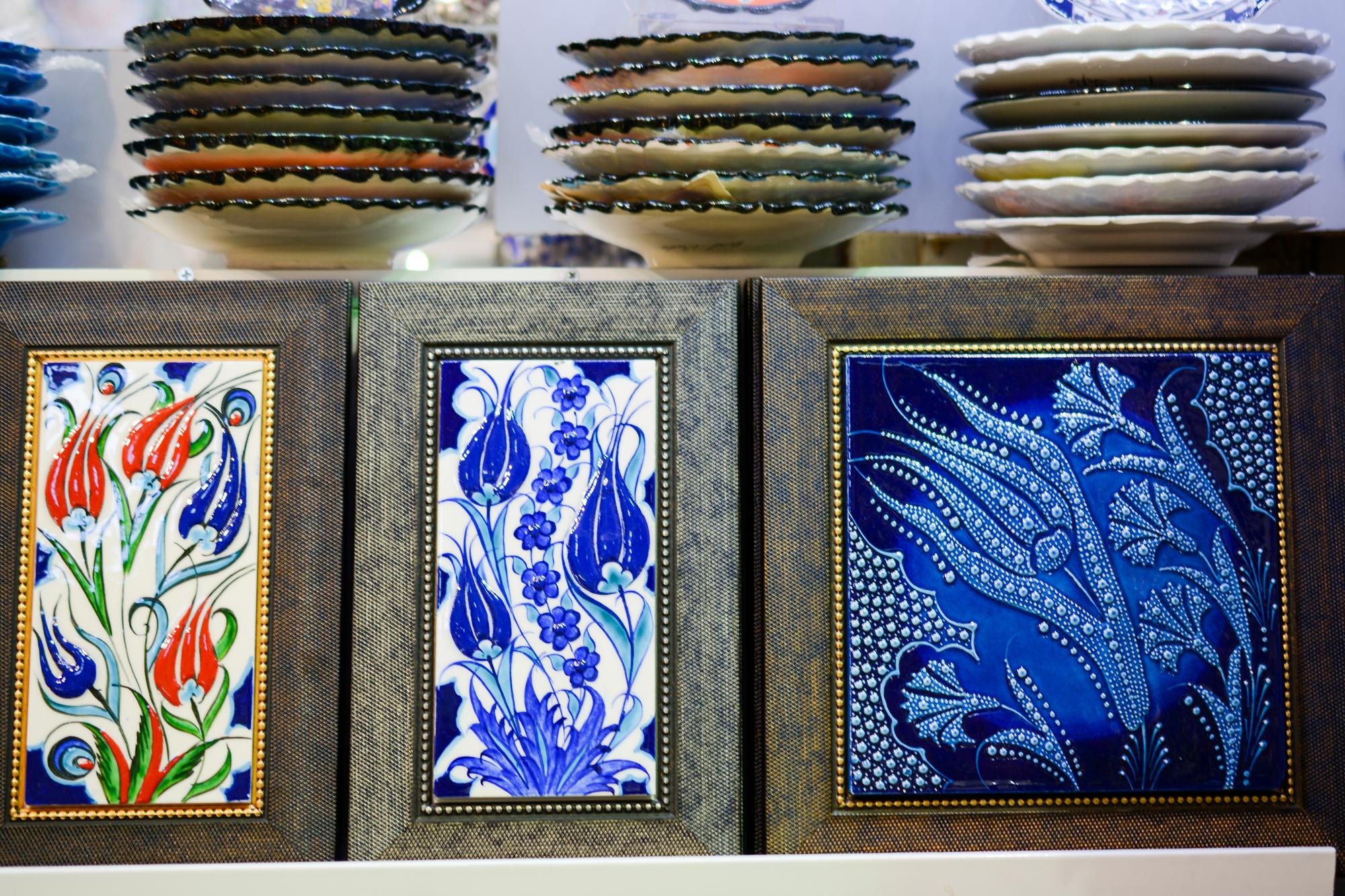 Workshop wall with framed embroidered samples