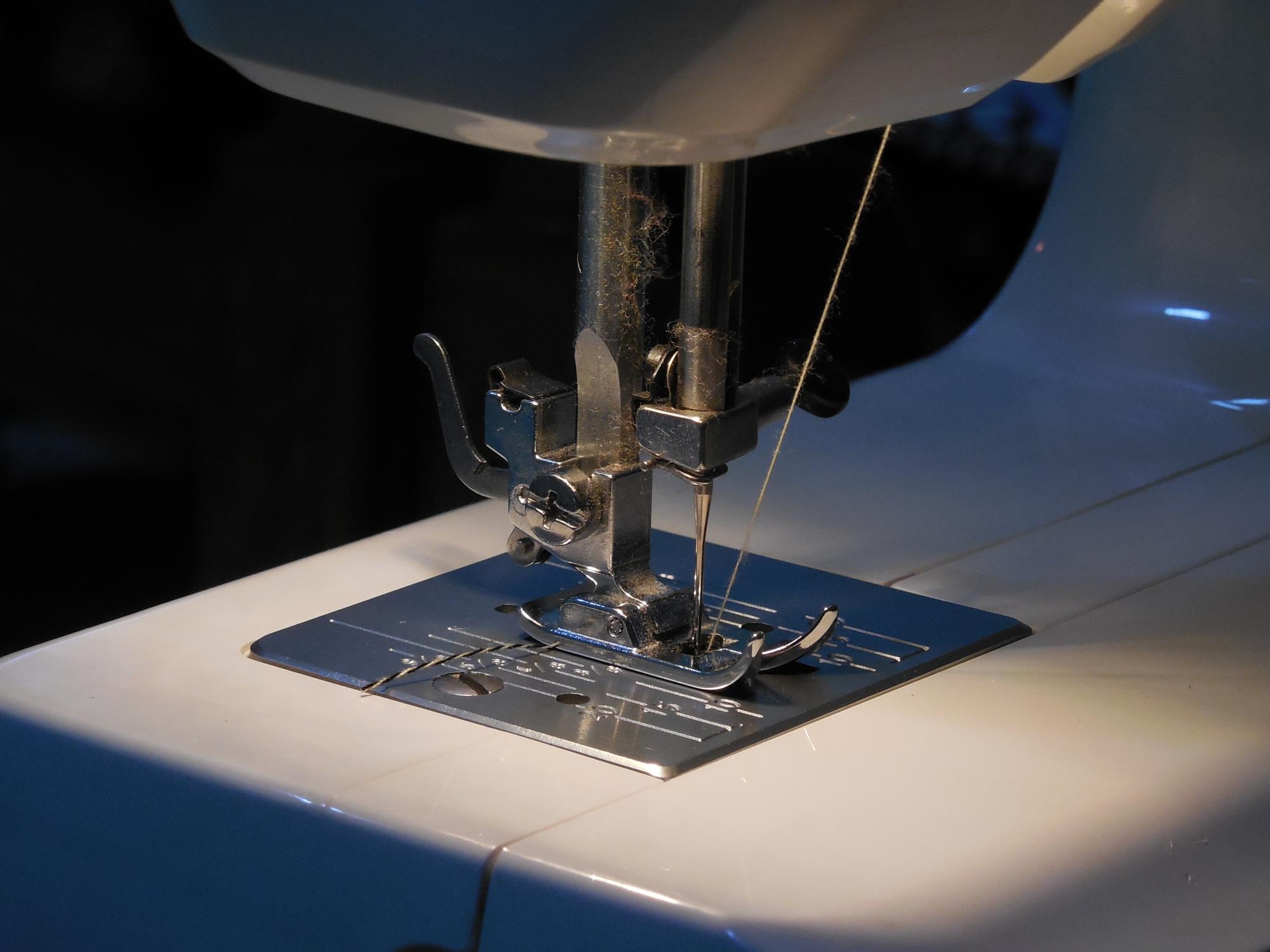 Close-up of high-tech embroidery machine stitching blue thread